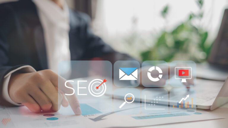 A business person at a computer shows the results of seo management work.
